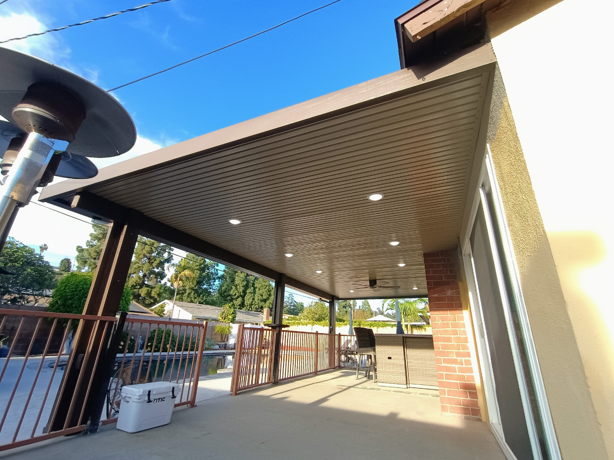 Custom outdoor living space with wood-grain aluminum patio cover, Inland Empire