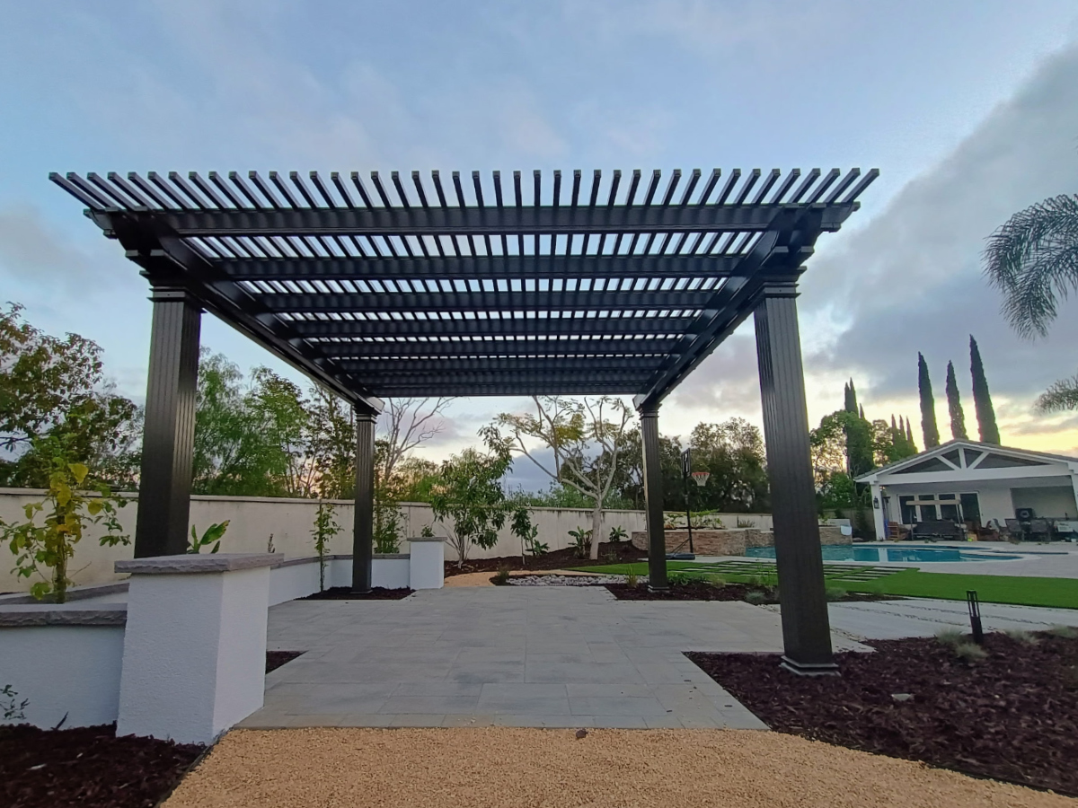 Backyard aluminum patio cover extending across full rear elevation of home