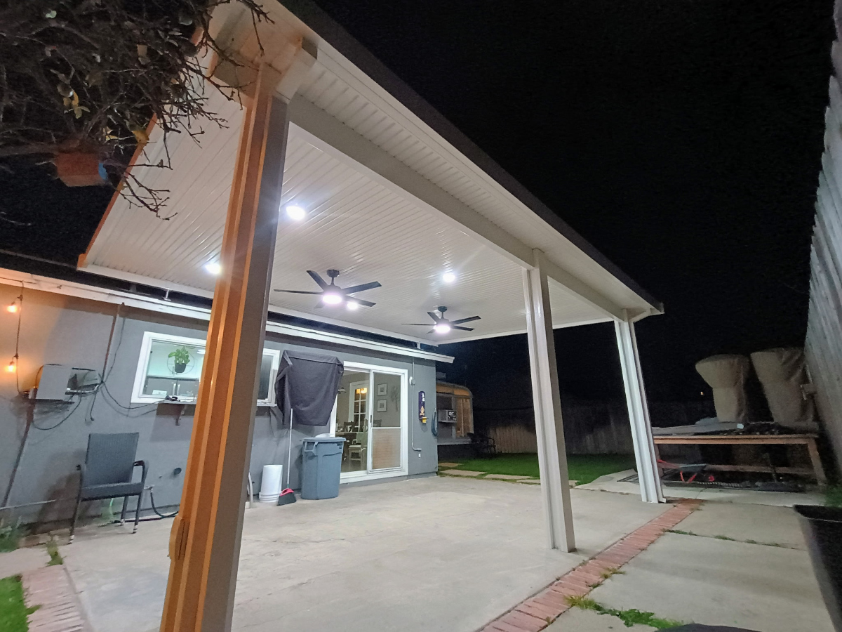 Aluminum patio cover installation extending the home's living space outdoors